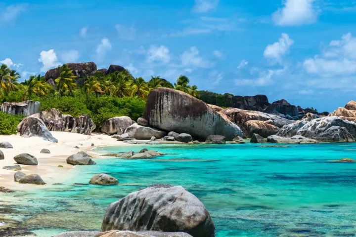 a rocky beach next to the water